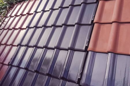 Samples of ceramic roofing tiles in a warehouse of a roofing materials store. Modern roof made of metal. cement sand tiles.の写真素材
