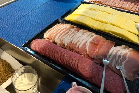 Sausage and cheese sliced on a tray in the dining room.の写真素材