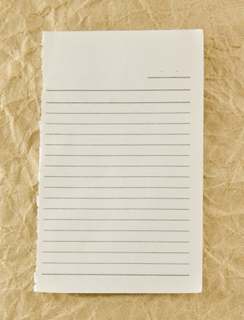 white lined paper on brown backgroundの写真素材
