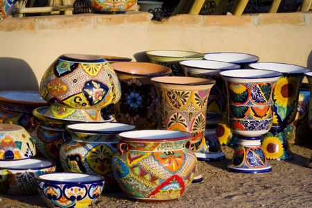 Stacks of Colorful Mexican Pottery at Sunsetの写真素材