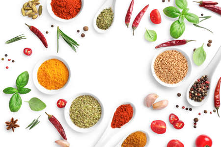 Top view of various spices, herbs and seasonings isolated on white background. Copy space.