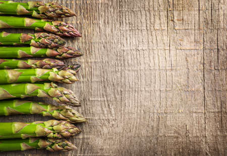Fresh asparagus on wooden background. Top view. Copy space.の写真素材