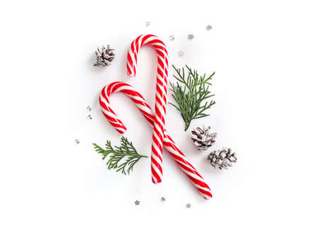Close up of two candy canes tied with ribbon bow on white background