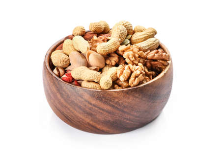 Mixed nuts in wooden bowl isolated on white background.