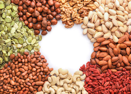 Frame of mixed nuts on white background. Top view. Copy space.