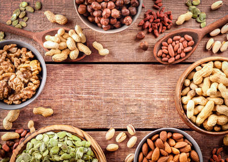 Mixed nuts on wooden background. Top view. Copy space.