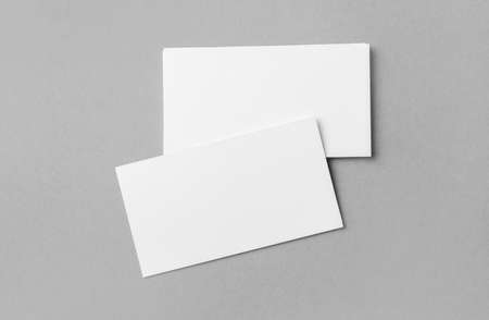 Blank business cards on gray background. Top view.