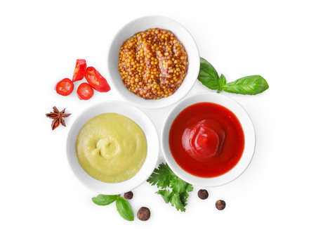Various sauces in small bowls isolated on white background. Top view.