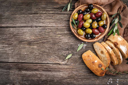Virgin olive oil, olives and fresh bread on the table. Top viewの写真素材