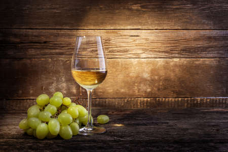 Grape and white wine on wooden background. copy spaceの写真素材