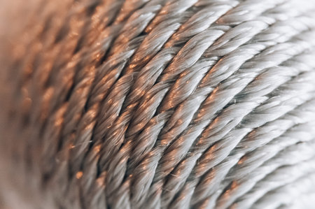 A warm, soft focus gradient characterizes this abstract rope texture background, featuring subtle...