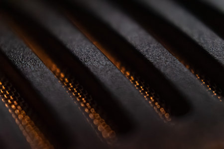 Macro closeup selective focus on copper texture featuring raised parallel elements. Abstract detail...