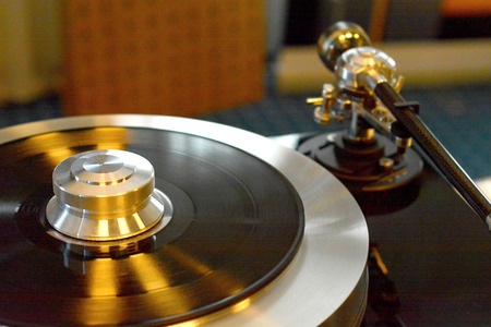 Audiophile turntable with vinyl record. Focus on turntables shiny platter.の写真素材
