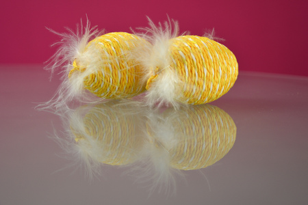 Braided Easter eggs decorated with feathersの写真素材