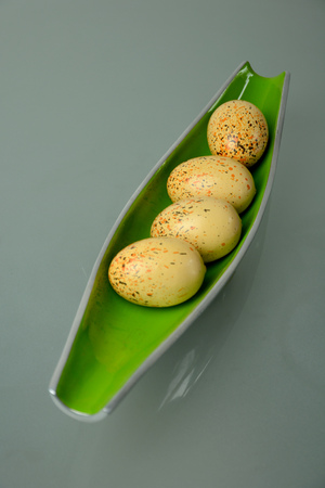 Three easter eggs on a beautiful bowlの写真素材