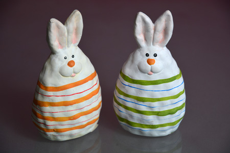 Easter ceramic bunny on glass backgroundの写真素材