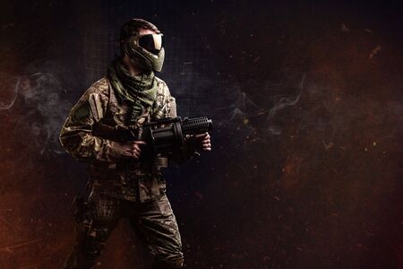 Paintball Tactical male fighter with grenade launcher.