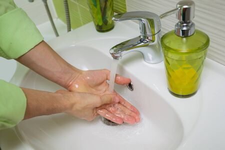 Mens hands are near the sink. Washing Hands. Cleaning Hands.の写真素材