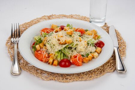 Caesar salad with salmon on white tableの写真素材