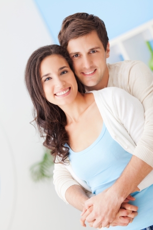 Happy young couple in their modern living room.の写真素材