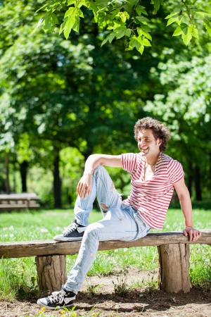 A young handsome man enjoying himself at the park.の写真素材
