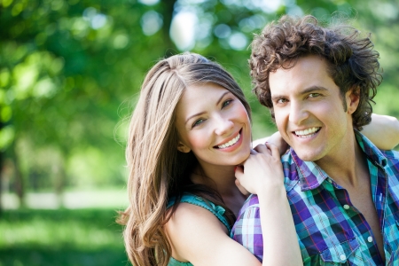 Close-up of young romantic couple on a sunny day in the park.の写真素材