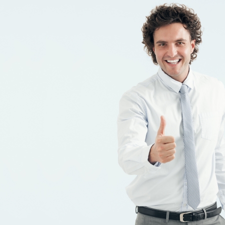 Close-up of a successful young businessman showing thumbs up の写真素材