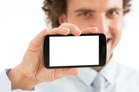 Portrait of a smiling businessman showing a blank contemporary smart phone on white background の写真素材