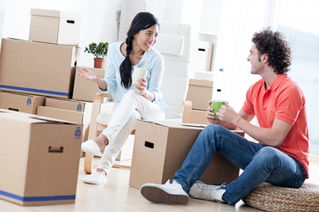 Happy couple moving into a new apartment の写真素材