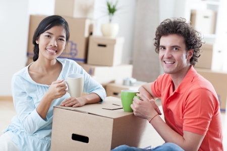 Happy couple moving into a new apartment の写真素材