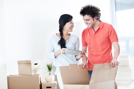 Happy couple moving into a new apartment の写真素材
