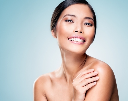 A beautiful Asian model posing and smiling.の写真素材