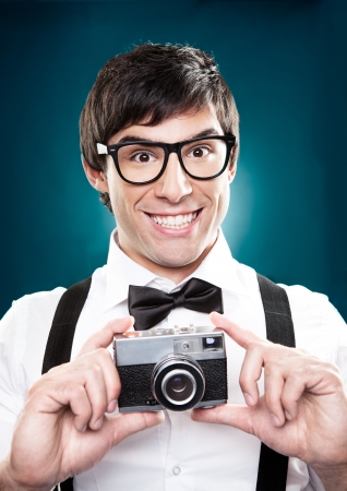 A handsome man taking photos using an old camera.の写真素材