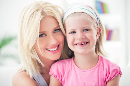 Mother and her daughter posing and smiling.の写真素材