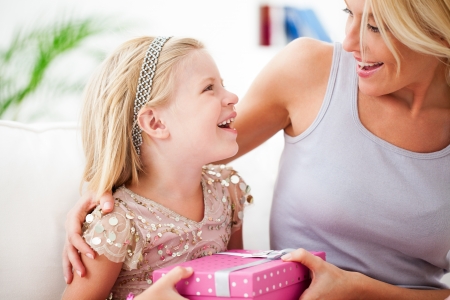 Mother and daughter sharing the happy birthday moments together.の写真素材