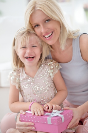 A mother and her daughter sharing happy moments together for the girl's birthday.の写真素材