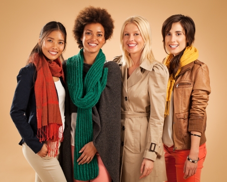 Group of smiling women wearing warm clothes.の写真素材