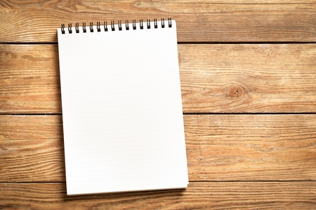 Blank notepad on a wooden surface.の写真素材