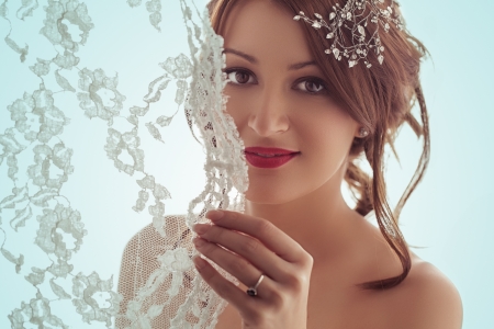 Portrait of a beautiful bride smiling behind her veil.の写真素材