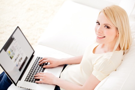Beautiful young woman working at home.の写真素材