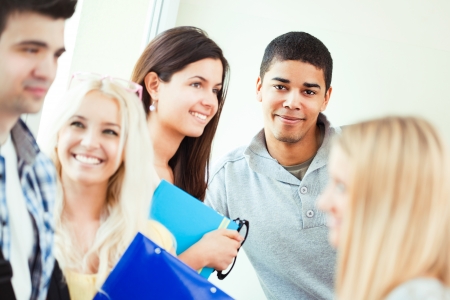 Portrait of a smiling African college student surrounded by his peers.の写真素材