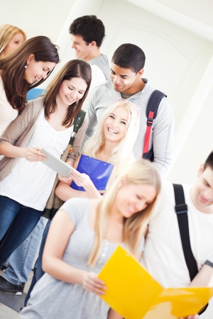 Large group of university students standing together in the hallway.の写真素材