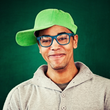 Smiling African rapper wearing a cap and blue glasses.の写真素材