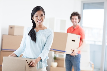 Happy couple moving into a new apartment.の写真素材