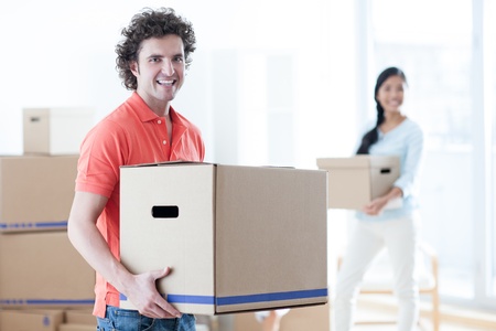 Happy couple moving into a new apartment.の写真素材