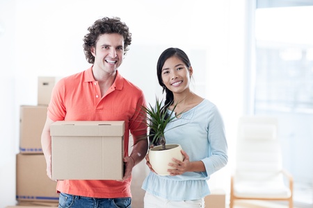 Happy couple moving into a new apartment.の写真素材