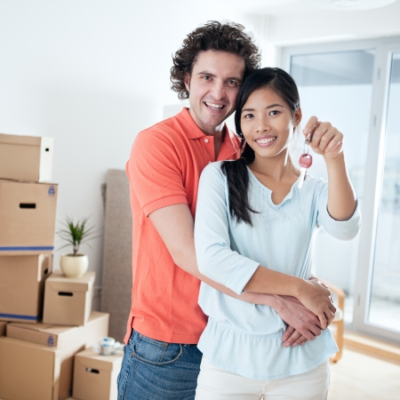 Happy couple moving into a new apartment.の写真素材