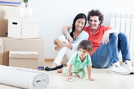 Young happy family relaxing after they have moved into their new home.の写真素材