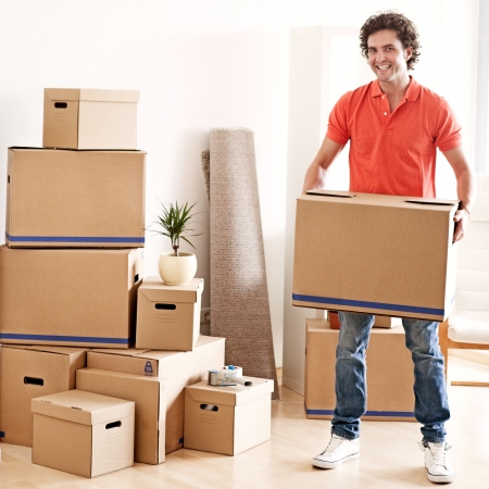 A young handsome man moving into a new apartment.の写真素材