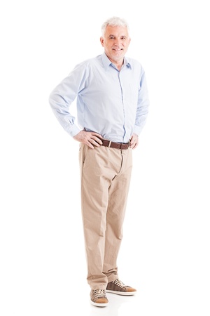 Casually dressed senior man posing with his arms akimbo.の写真素材